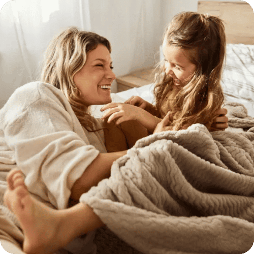 mom and daughter hanging out in bed doing a mindful minute