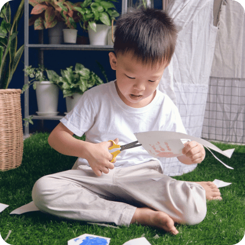 a little boy doing an outdoor art project
