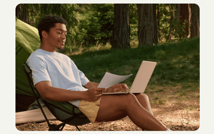 A person relaxes outdoors near a tent with a laptop and document, alongside a UI overlay showing Cards Optimizer rewards data.