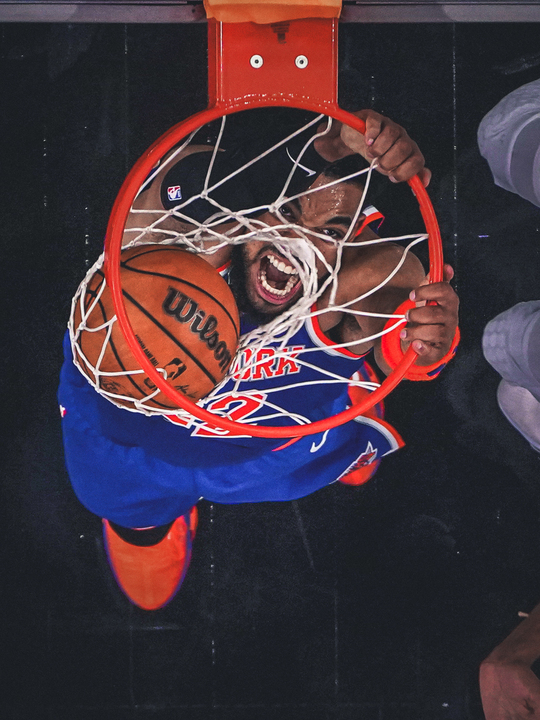 Karl-Anthony Towns dunks, seen from above the basket.