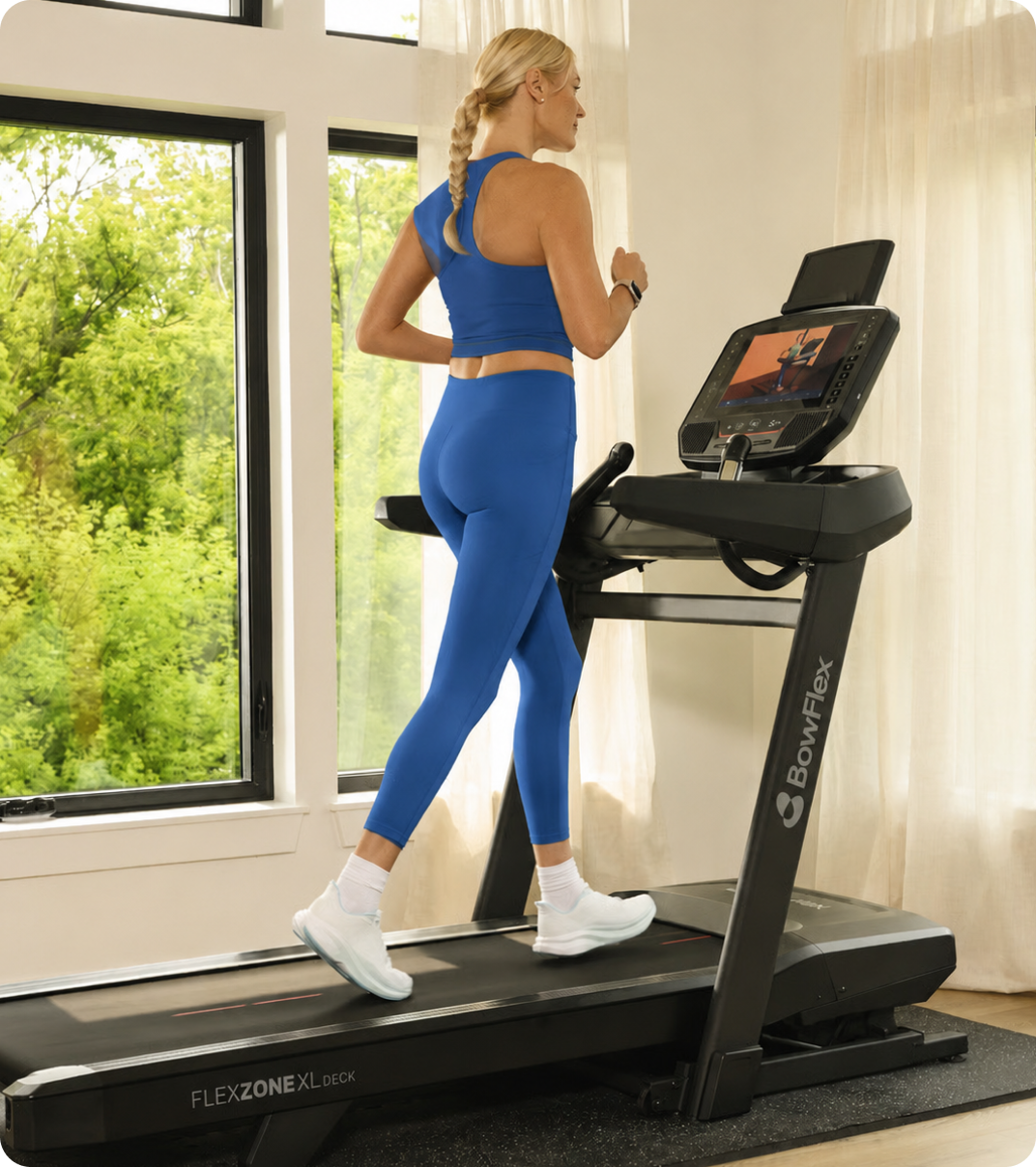 Woman running on a Bowflex treadmill at home.