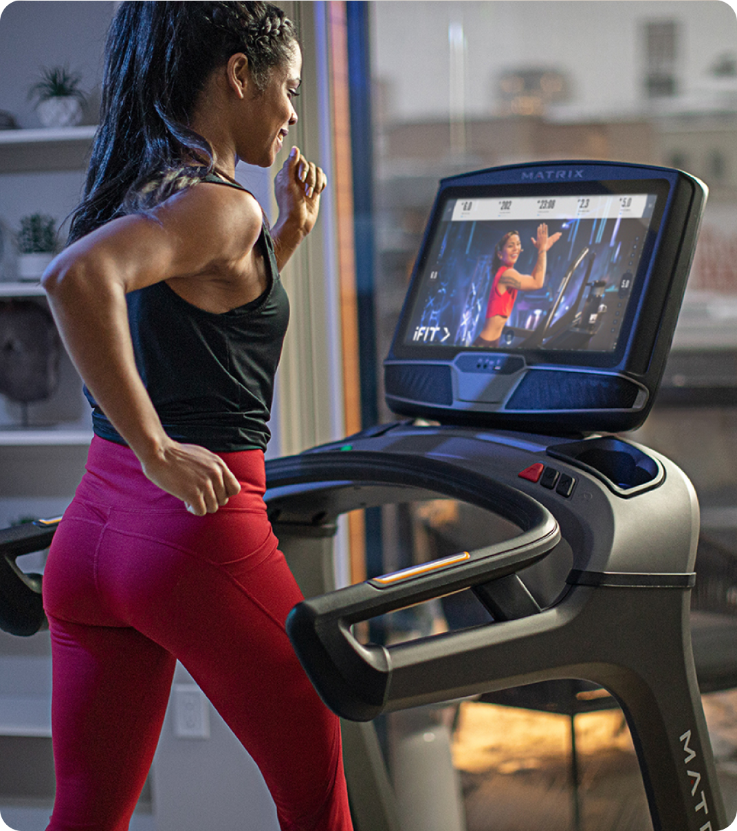 Woman running on a Matrix Treadmill at home.