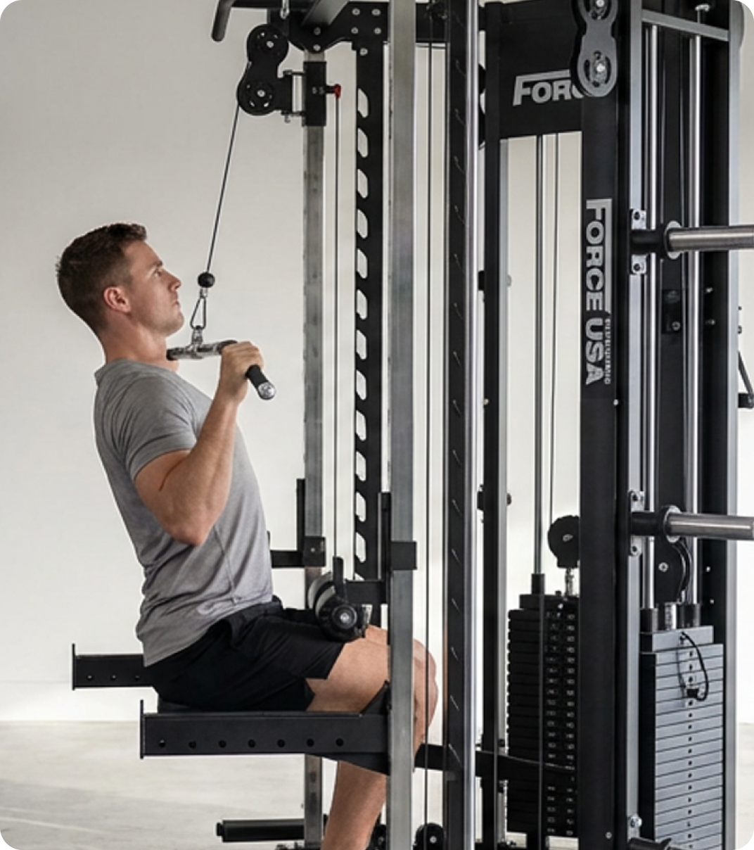 Man doing strength training with a Force USA All-In-One Trainer.