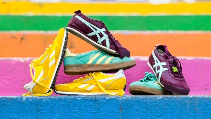 Three pairs of sneakers perched on colorful stairs