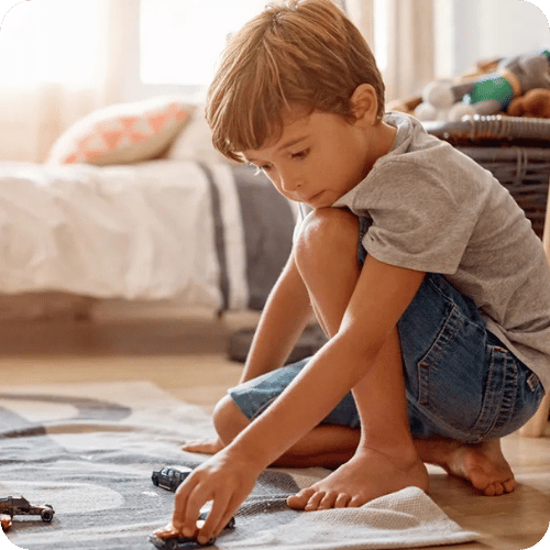 a little boy playing with toy cars, a great indoor summer activity
