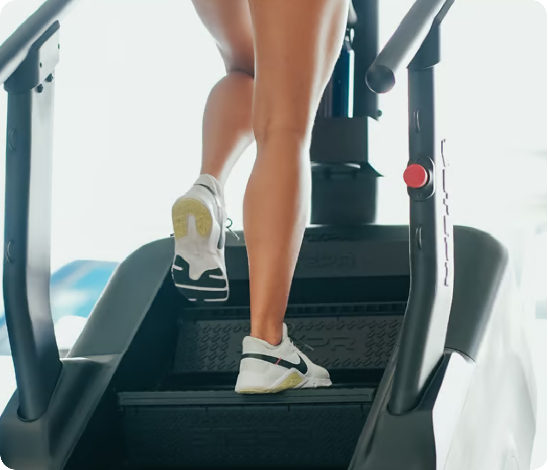 Close-up of a person’s feet stepping on a STEPR machine.