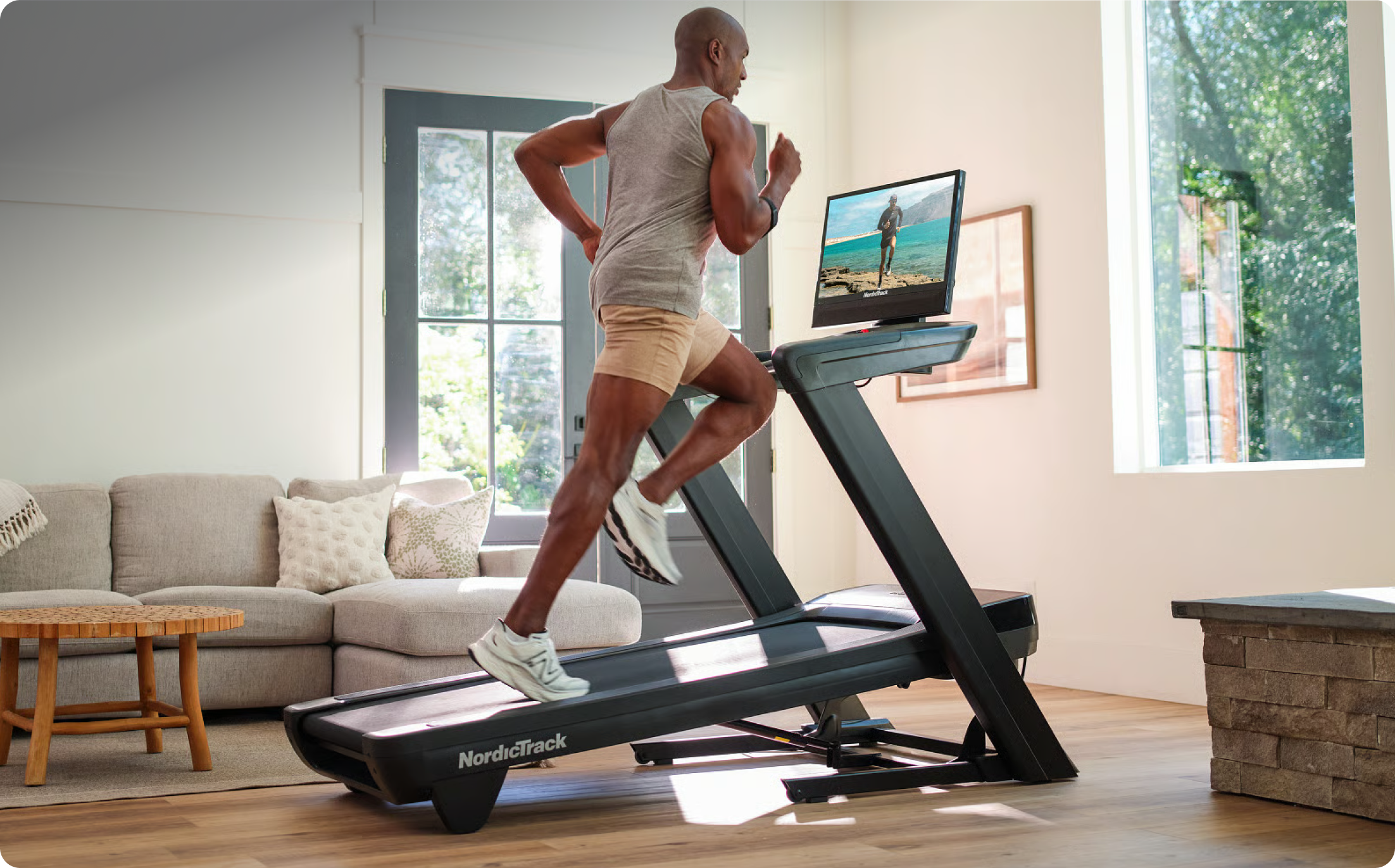 Man running on a NordicTrack Commercial 2450 treadmill at home. Man running on a NordicTrack Commercial 2450 treadmill at home.
