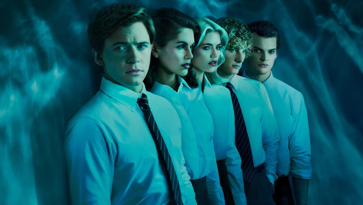 From The Shards TV show, Five teenagers in white button-down shirts and school ties stand in a diagonal line against a moody blue backdrop. All have  serious, unsettling expressions.