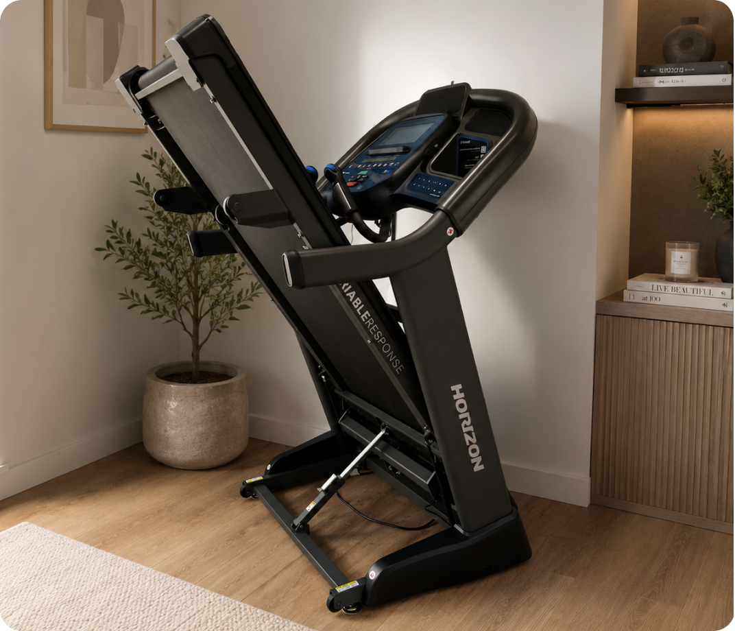 Horizon folding treadmill folded upright for compact home storage.
