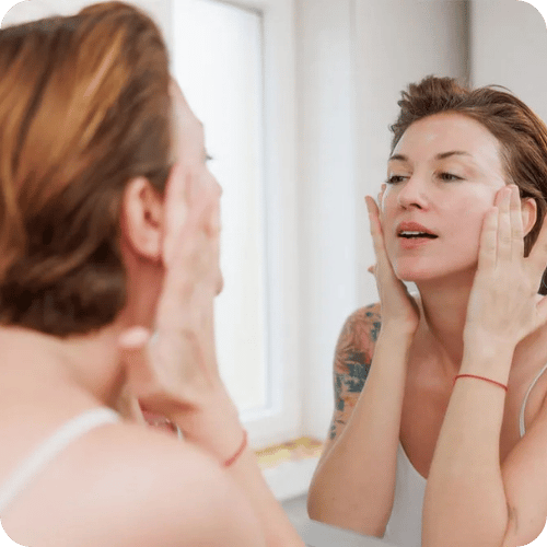a woman washing her face with an unsexy dermatologist recommended product