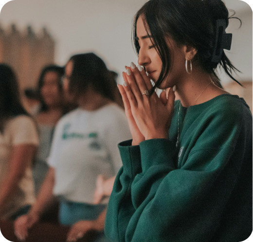 A woman praying with her community