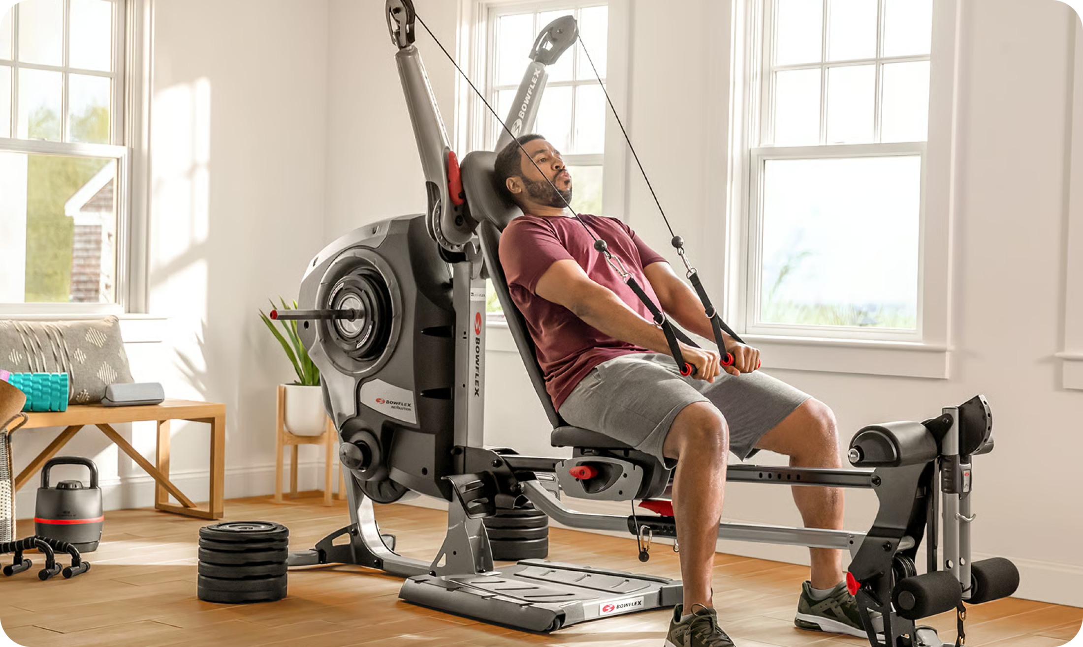 Man training at home on the BowFlex Revolution Home Gym. Man training at home on the BowFlex Revolution Home Gym.