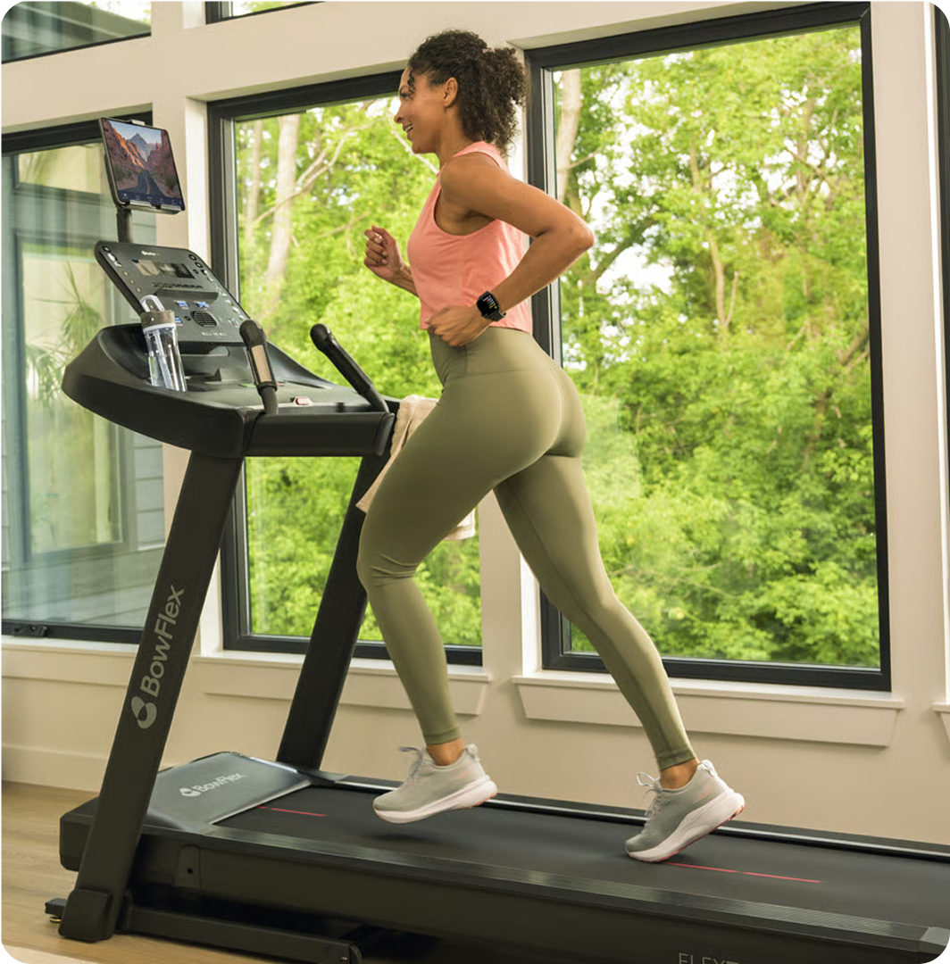 Woman running on a BowFlex treadmill at home