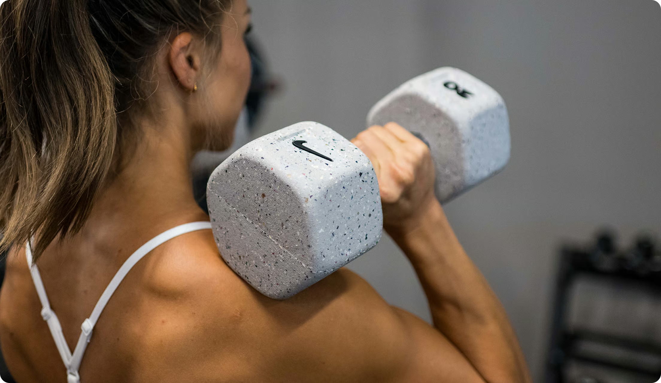 Woman strength training with Nike Grind dumbbells