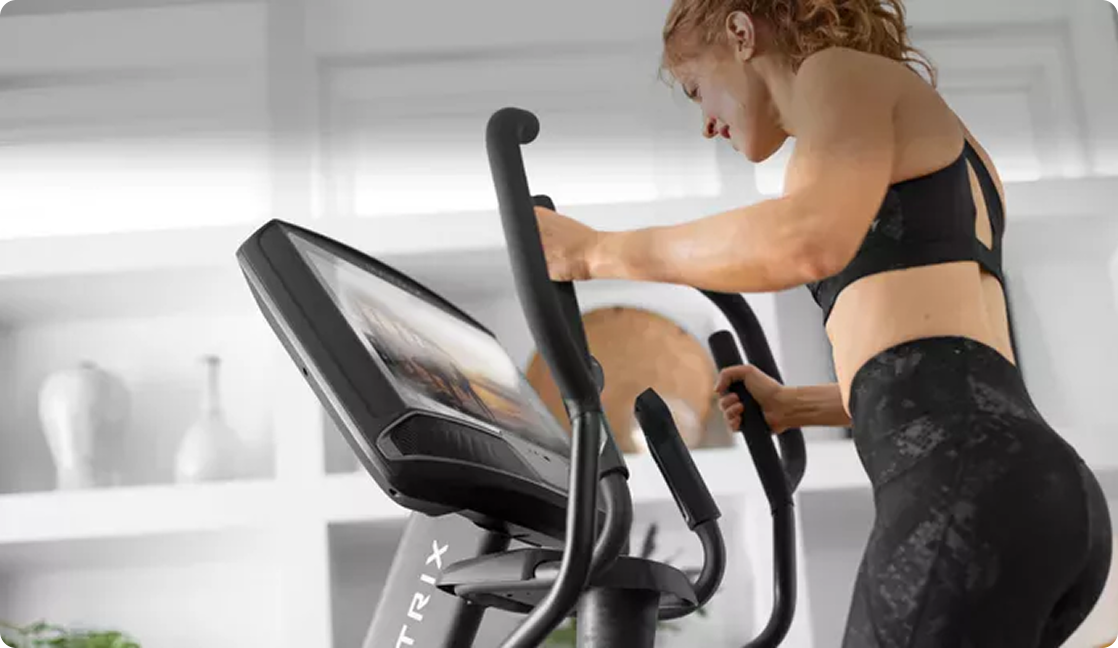Woman working out on a Matrix elliptical at home