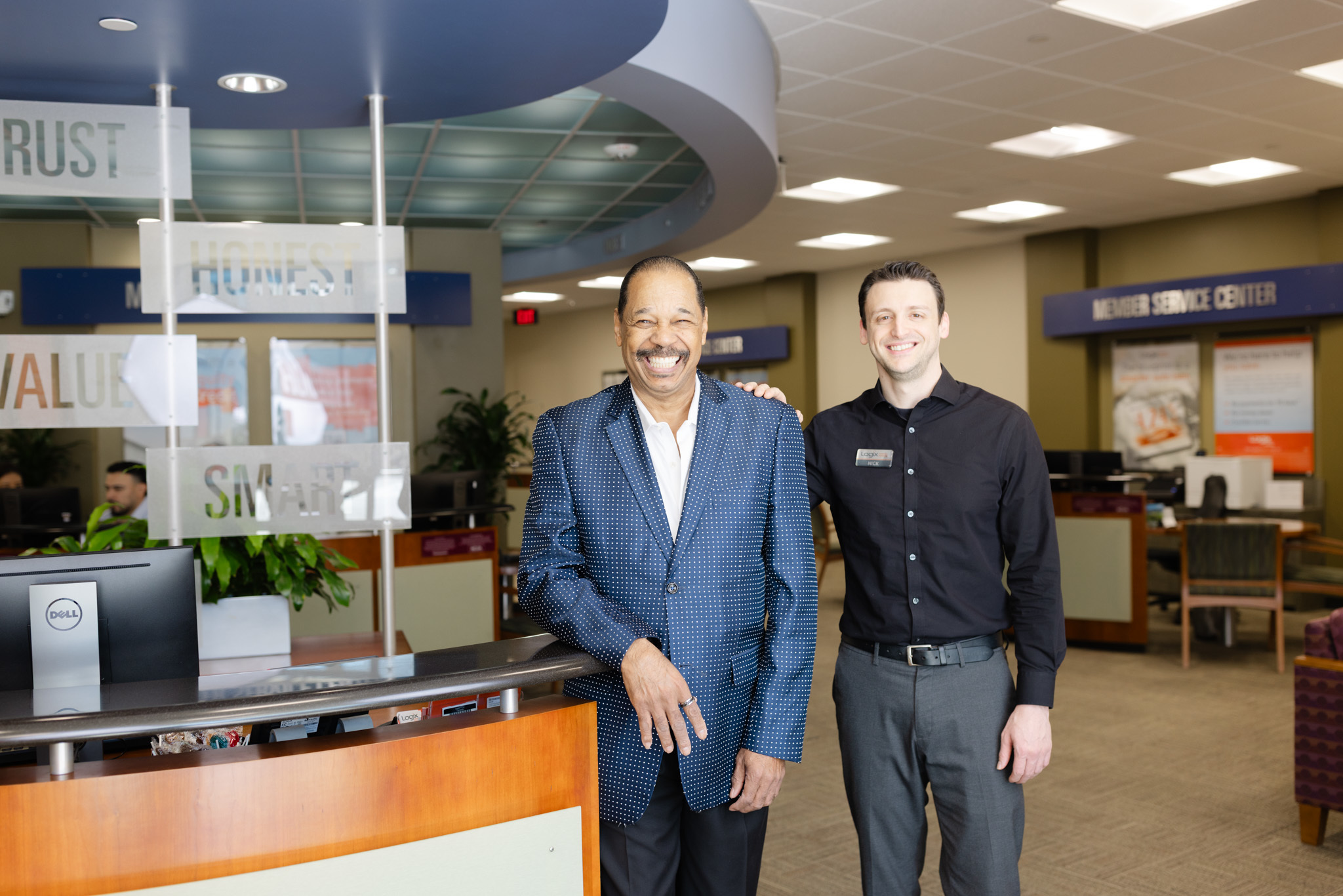 Smiling Logix member with a Logix team member inside a Logix branch
