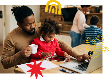 A father holding a mug while his daughter uses a tablet, with a laptop and papers on the table