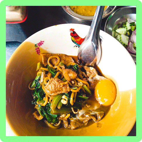 Image Description: A dish of noodles, egg yolk, and chicken